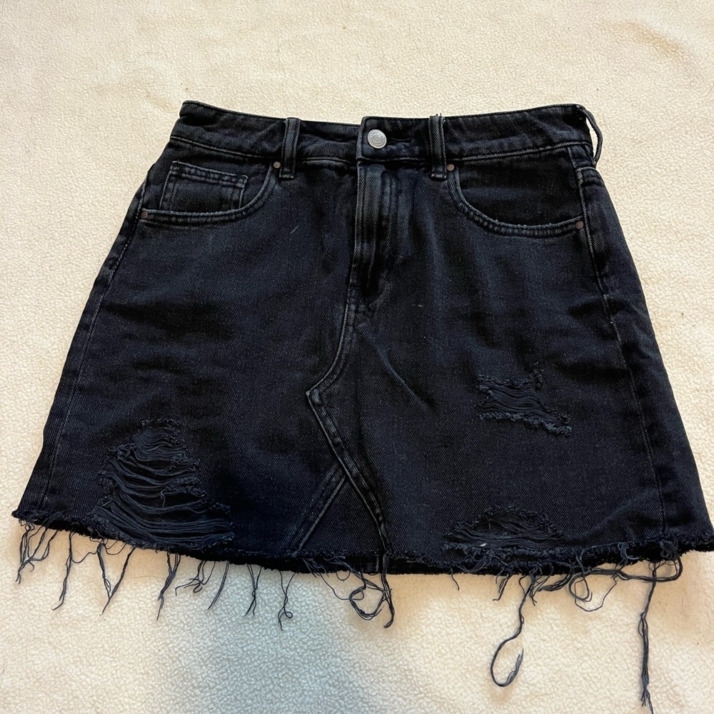 Black packs in jean skirt
